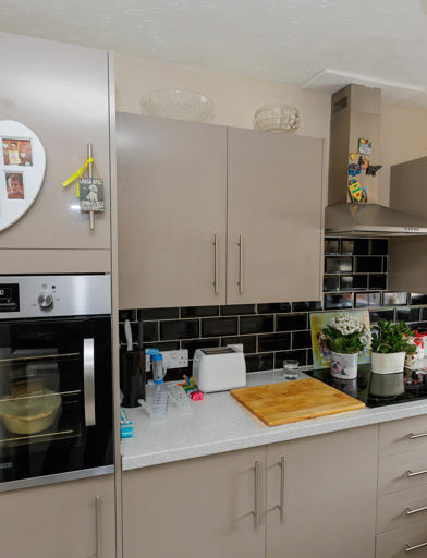 A bungalow kitchen with beige cupboards 