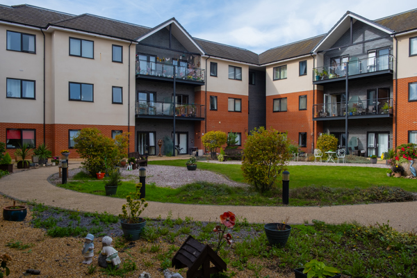 Inside one of the communal gardens with a circular pathway surrounded by plants and flowers