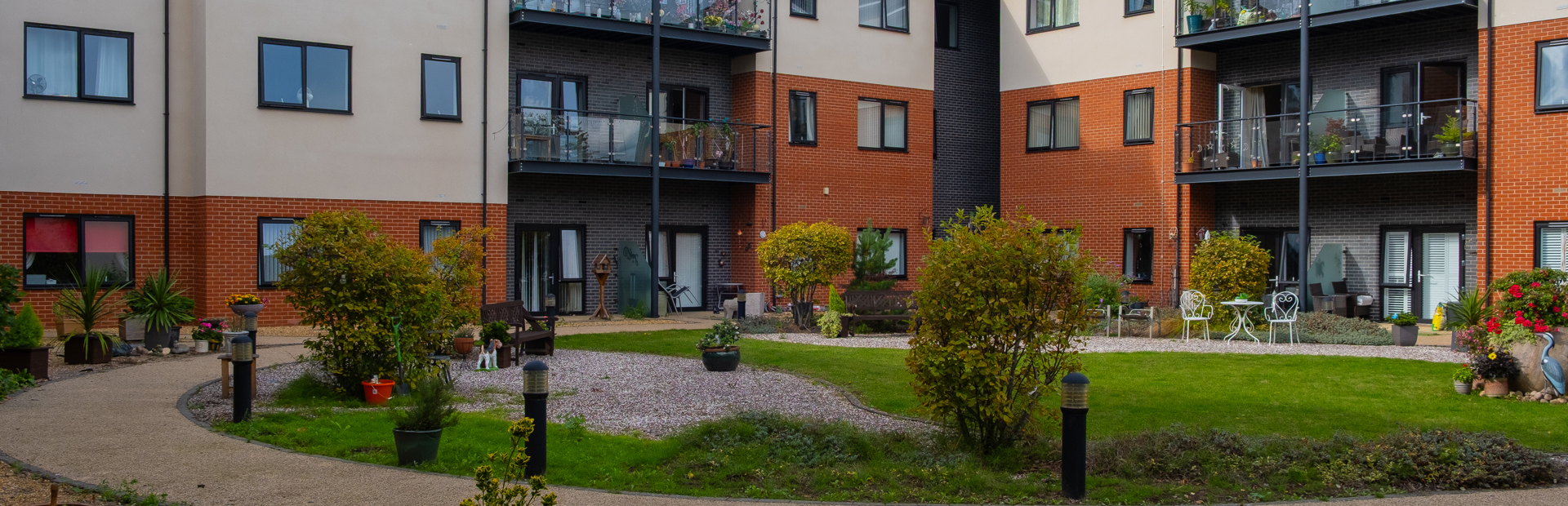 Inside one of the communal gardens with a circular pathway surrounded by plants and flowers