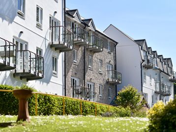 Side view of the building from the garden area on a sunny day