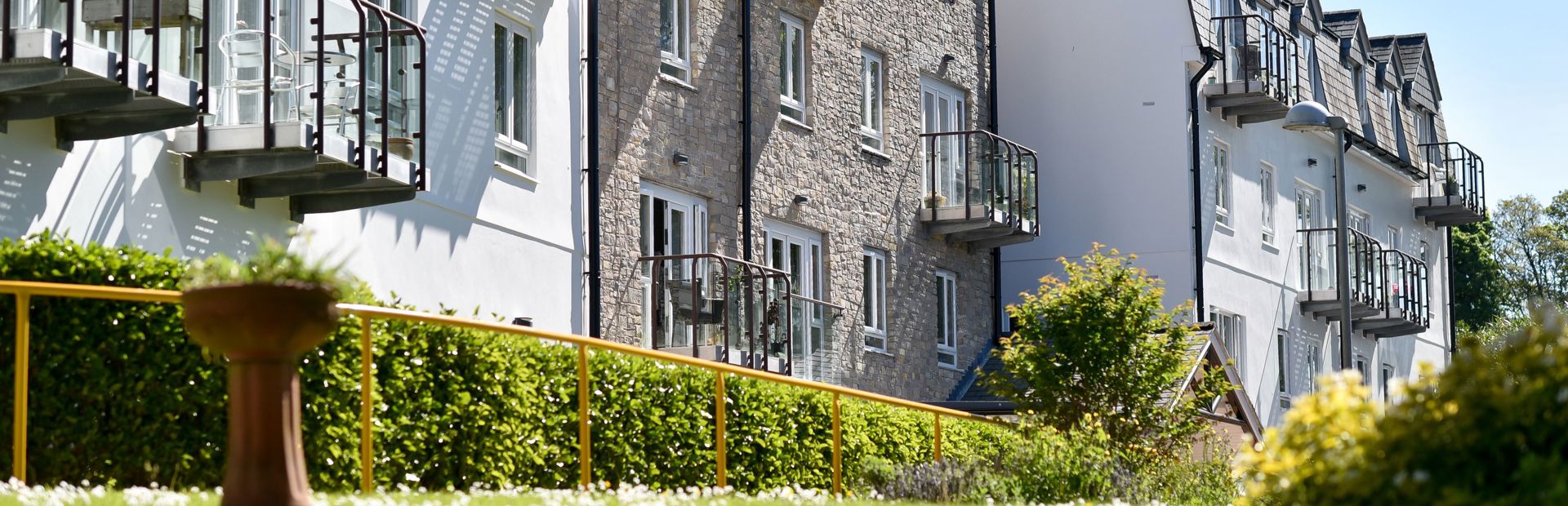 Side view of the building from the garden area on a sunny day