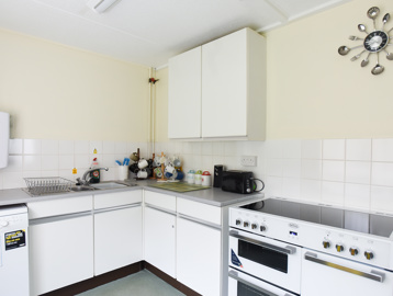 Communal kitchen with large double-oven, dishwasher, toaster and water heater