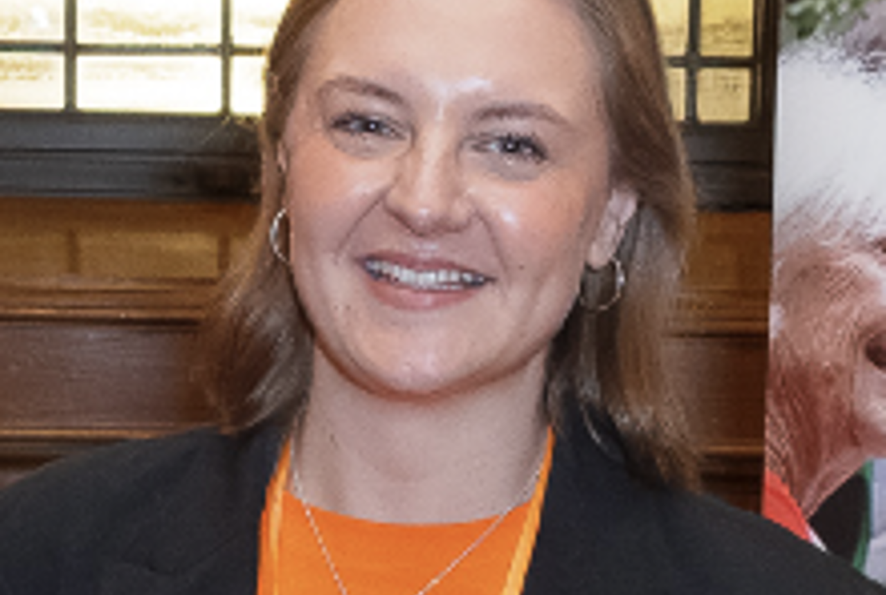 A woman smiles at the camera