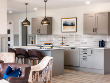 Communal kitchen area with modern units, seating and furnishings