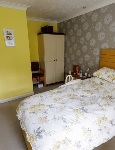 A bedroom that is yellow and grey 