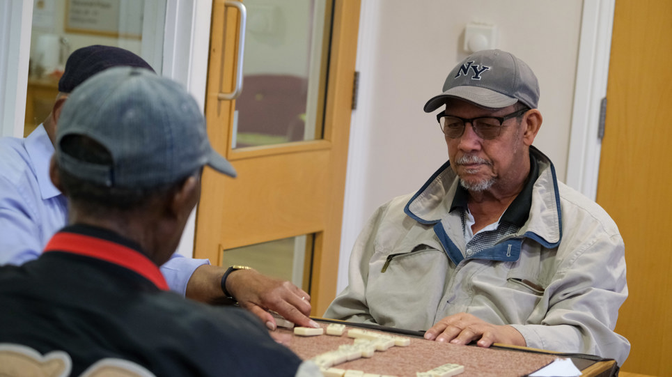 Three residents sitting down playing Scrabble 
