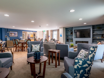 William Griffiths Court internal shot: Communal living room with arm chairs, sofas and blue decorations