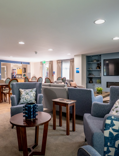 William Griffiths Court internal shot: Communal living room with arm chairs, sofas and blue decorations 