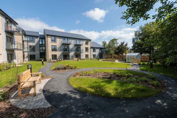 An image showing the outer building of Housing 21's Extra Care scheme, Bowland View surrounded by tree's and grass