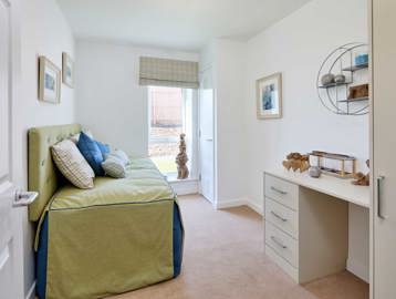 Spare bedroom inside an apartment at Filey Fields featuring a sofa bed and dressing table