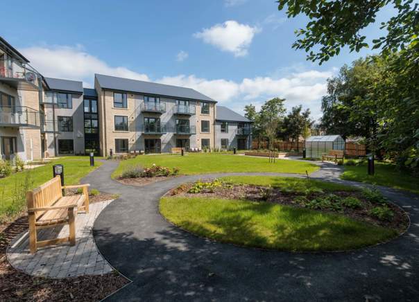 An image showing the outer building of Housing 21's Extra Care scheme, Bowland View surrounded by tree's and grass