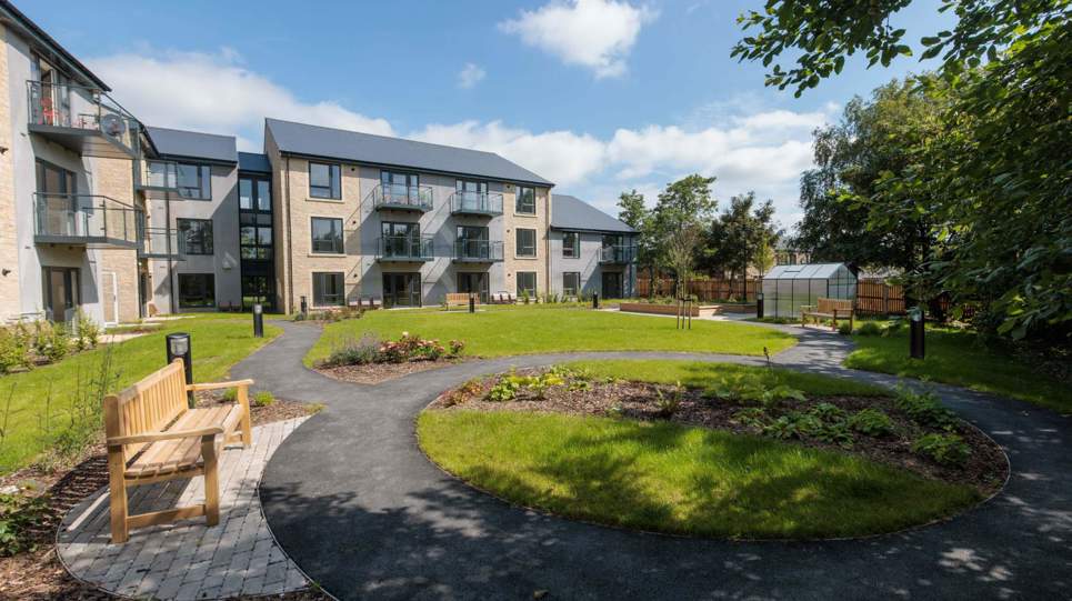 An image showing the outer building of Housing 21's Extra Care scheme, Bowland View surrounded by tree's and grass