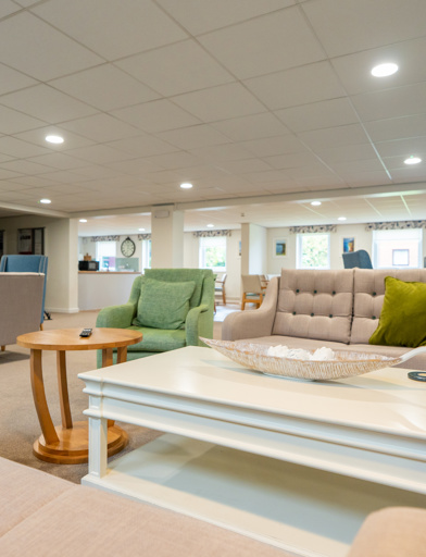 Bright and open communal living space with sofas and armchairs 