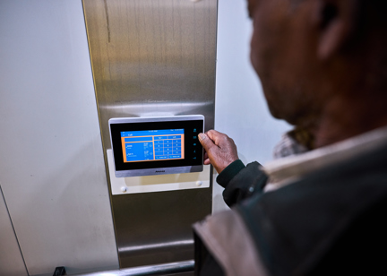 Resident using touch screen device 