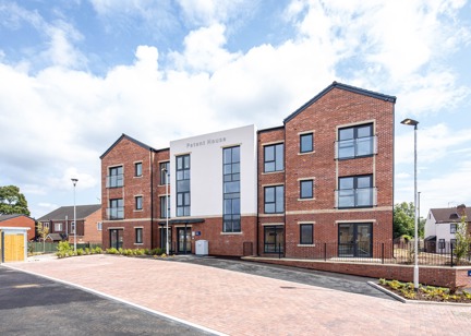 A three storey Retirement Living building, Patent House and Walk with a car park at the entrance 