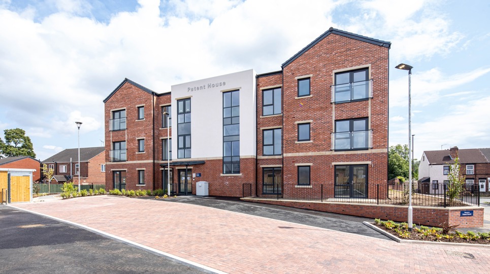 A three storey Retirement Living building with a car park at the entrance 