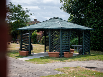Outside seating area in the garden with fixed gazibo