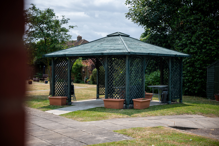 Outside seating area in the garden with fixed gazibo