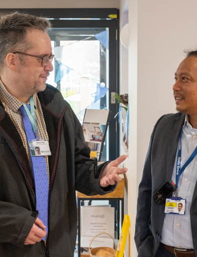 Two men in discussion in the Fern Meadow lobby 