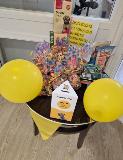 A table of dog treats and toys available to buy to raise funds 