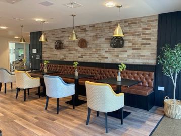 Dining chairs and tables in the bistro of Michaelmas Court 