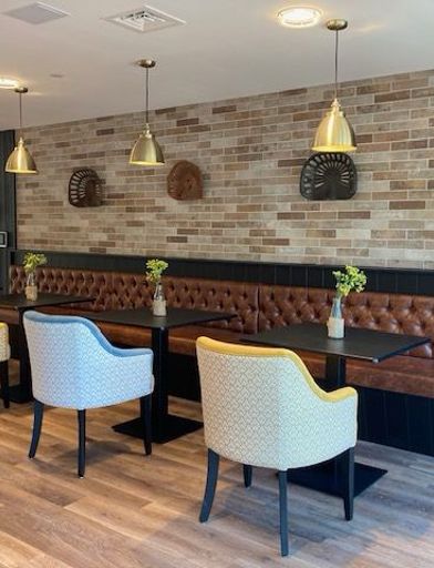 Dining chairs and tables in the bistro of Michaelmas Court  