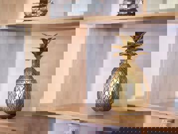 Gold pineapple ornament on a shelf