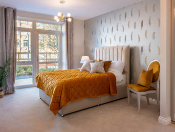 Inside the show home bedroom with double bed and side table