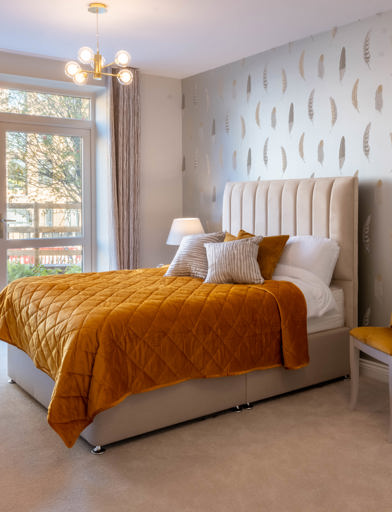 Inside the show home bedroom with double bed and side table 