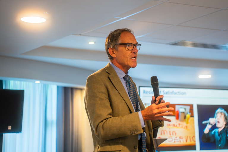 CEO Bruce Moore with microphone
