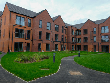 The back outer building of Askern Vale Court with a small back garden