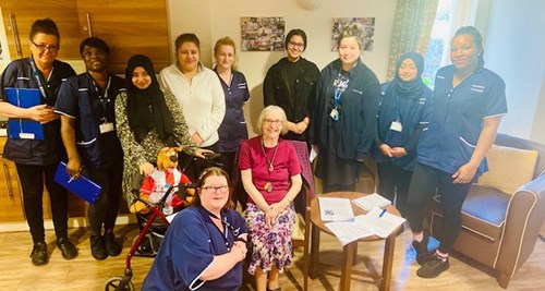 Pictured: The Care Team at Goldfield Court with a resident
