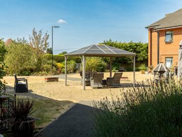 Communal garden at Oakwood Gardens. Featuring outdoor furniture and plants 