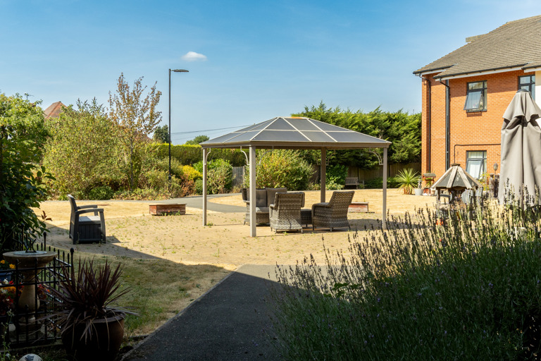 Communal garden at Oakwood Gardens. Featuring outdoor furniture and plants 