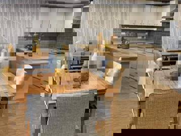 Communal kitchen and dining area with wooden flooring
