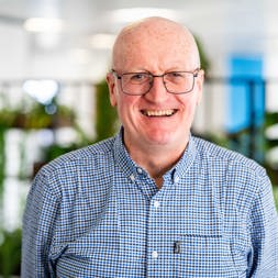 Housing 21 Resident Board Member, Richard Dell, smiles into the camera