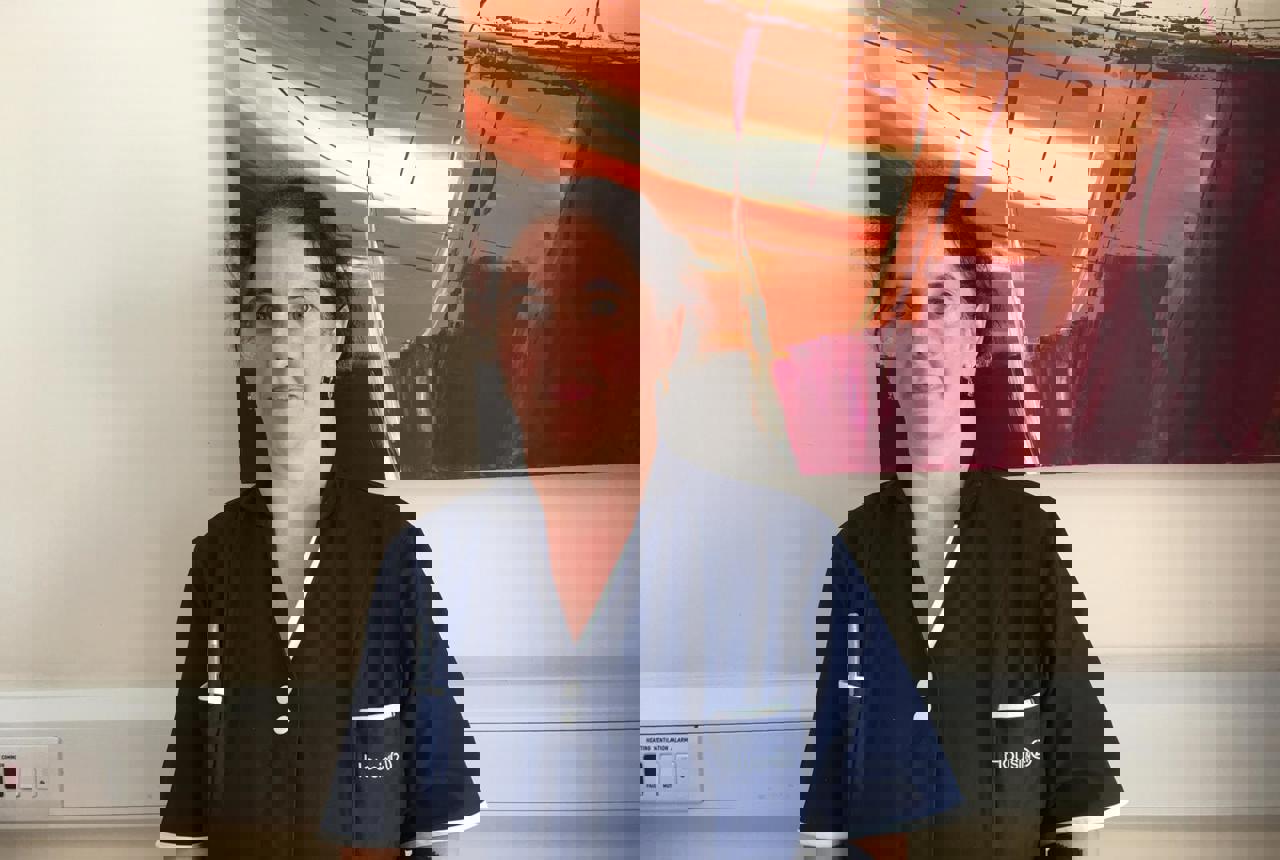 Claudia, in her Housing 21 uniform, facing the camera