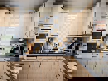 Communal kitchen area for residents to use with over, electric hob and microwave