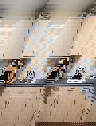 Communal kitchen area for residents to use with over, electric hob and microwave