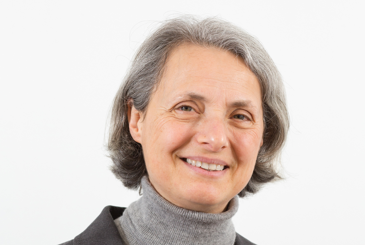A woman smiles at the camera