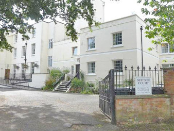 Gated entrance to the communal carpark at the front of the scheme