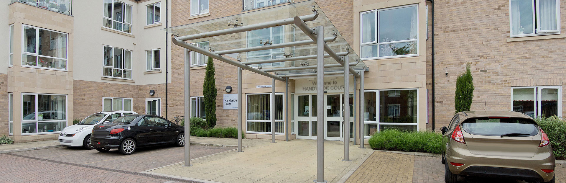 Main entrance to Handyside Court with car parking either side