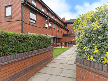Pathway around the outside of the scheme with hedgerow and plants either side