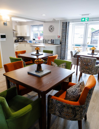 A modern and refurbished dining area with tables and chairs in a kitchen 