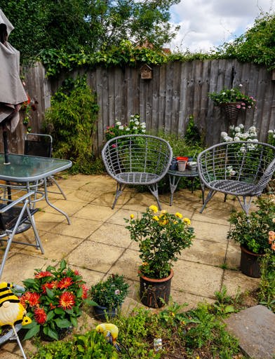 Outside garden with potted plants, and lovely seating area 