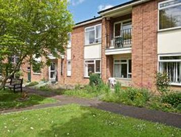A photo of the side of the building and garden area at Devonshire Court