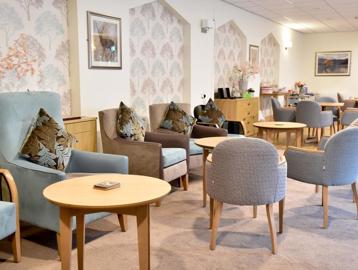 Comfortable seating and tables in lounge at Alan Hilton Court