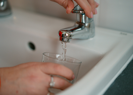 a tap with running water into a glass