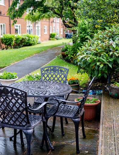Garden area with four pretty chairs and a table made of iron