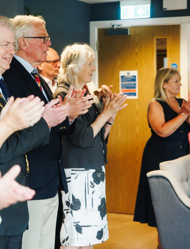 Guests applaud the end of a speech 